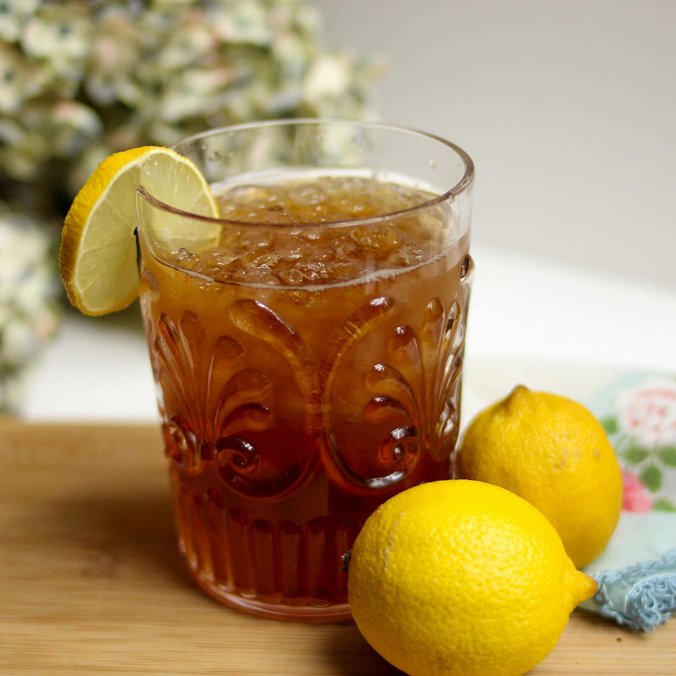 Glass of fresh ice tea with lemons as garnish