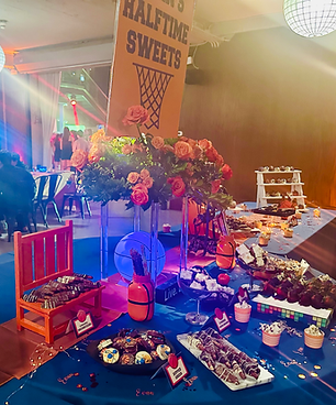 Basketball-themed Bar Mitzvah dessert table with custom florals, candy station and branded signage, designed by Frank Event Design Chicago