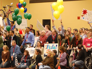 A corporate group energized to action by a motivational speaker