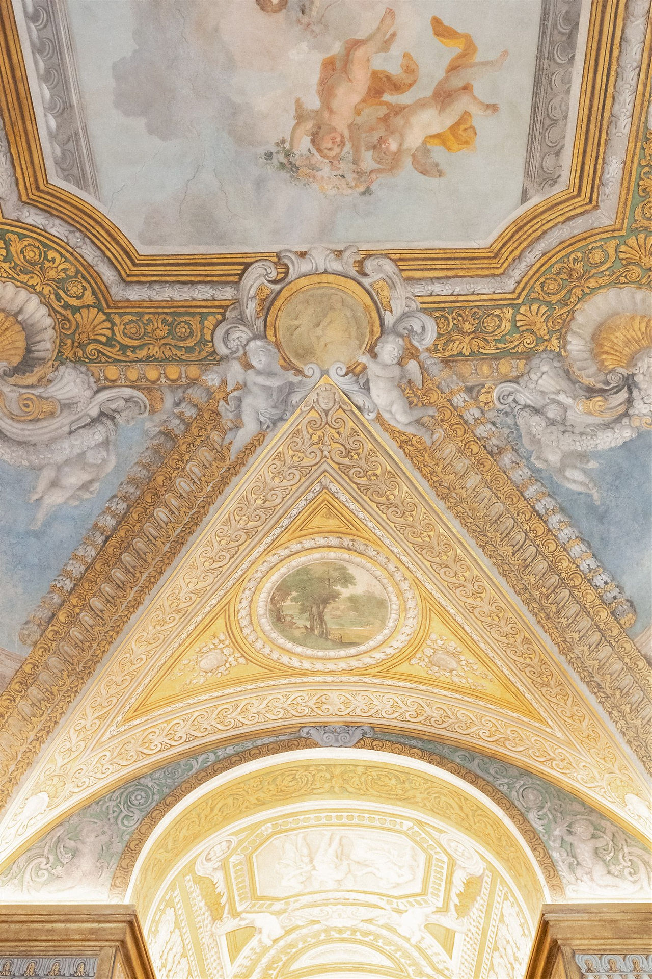 Ornate frescoed arched ceiling with gilded detailing inside Palazzo Shedir, a remarkable Italy wedding venue.