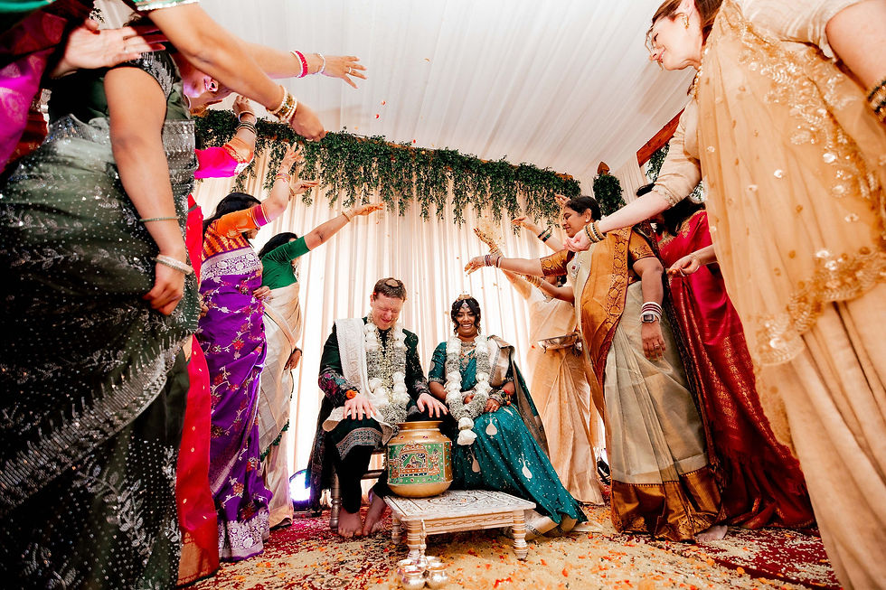 Wedding guests in colorful sarees and traditional jewelry at an Indian wedding ceremony