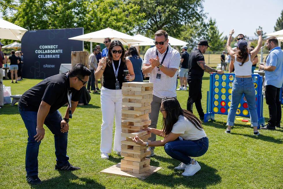 Corporate event attendees playing Jumbo Jenga and Giant Connect Four at an outdoor company picnic by Bright Light Events