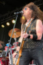 Guitarist performing live music on stage during an Illinois event.