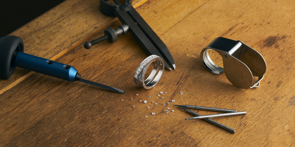 Diamond ring and jewelry tools on the table