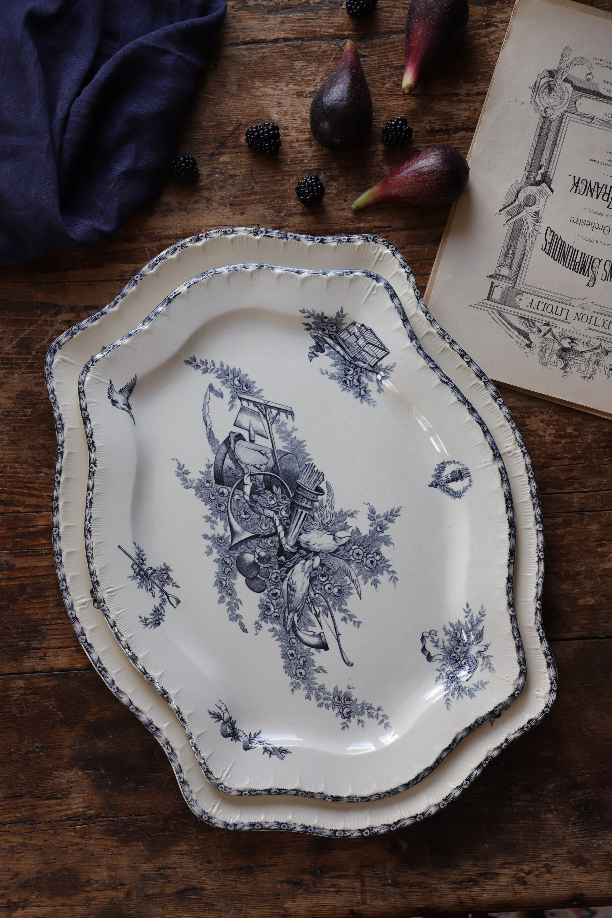 Pair of Sarreguemines dishes with birds and musical instruments