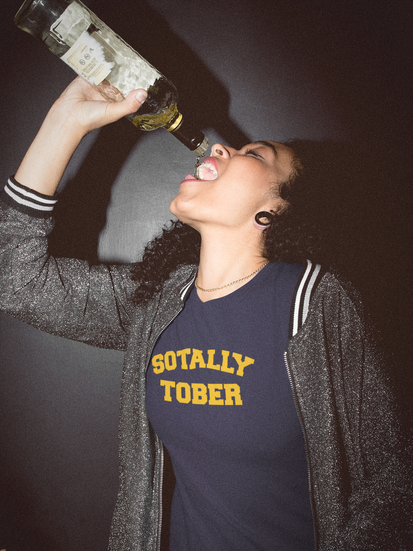 woman-drinking-rum-wearing-a-t-shirt-mockup-at-the-bar-a18816