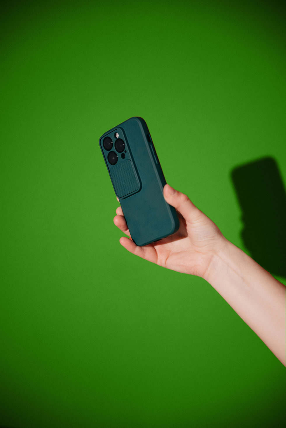 A hand holding a green phone symbolising the use of phones for social media.