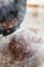 Roasted coffee beans cooling after being removed from roaster