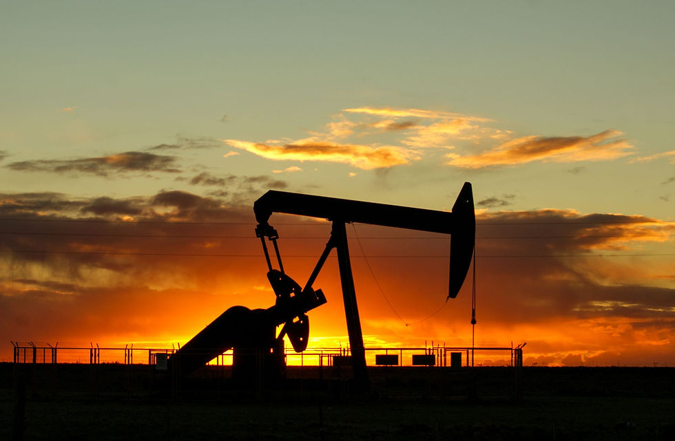 Oil pump jack silhouetted against a vibrant Texas sunset, representing the physically demanding oil field work common across South Texas