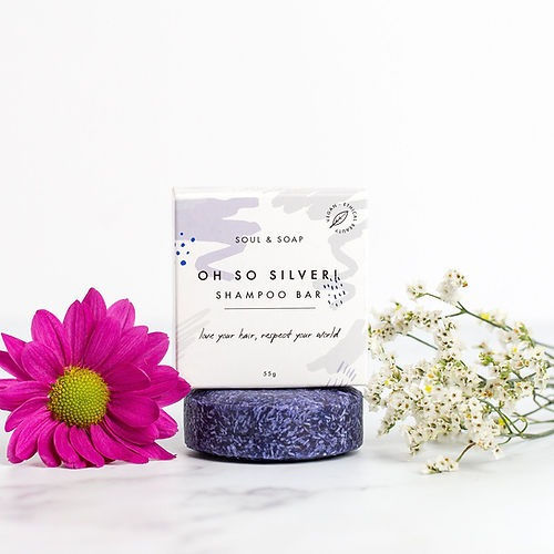 a purple plastic free shampoo bar a soul and soap box next to it 