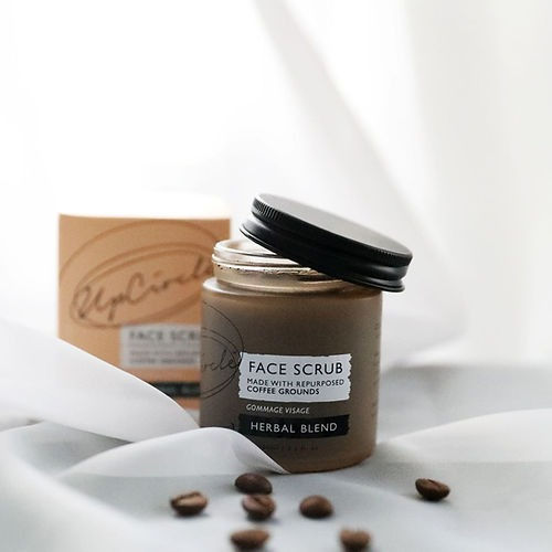 a glass jar with brown coffee facescrub from up circle