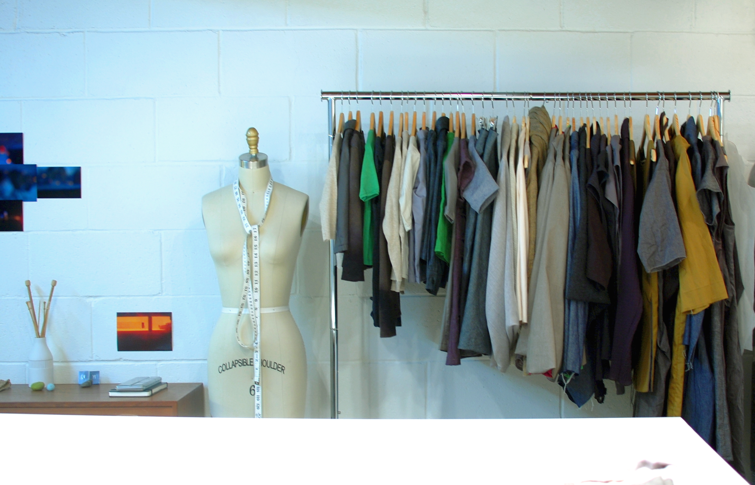 A clothing rack with garments on wooden hangers, used as an editorial illustration for fashion returns-policy planning.