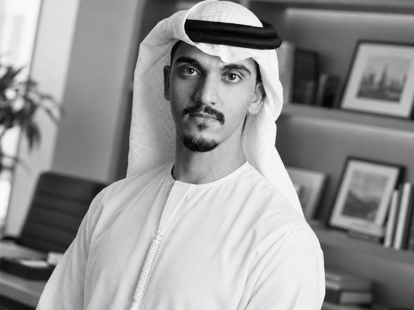 Black-and-white portrait of Ali Al Nowais, Chairman of EquiGroup, wearing a white kandura and ghutra.