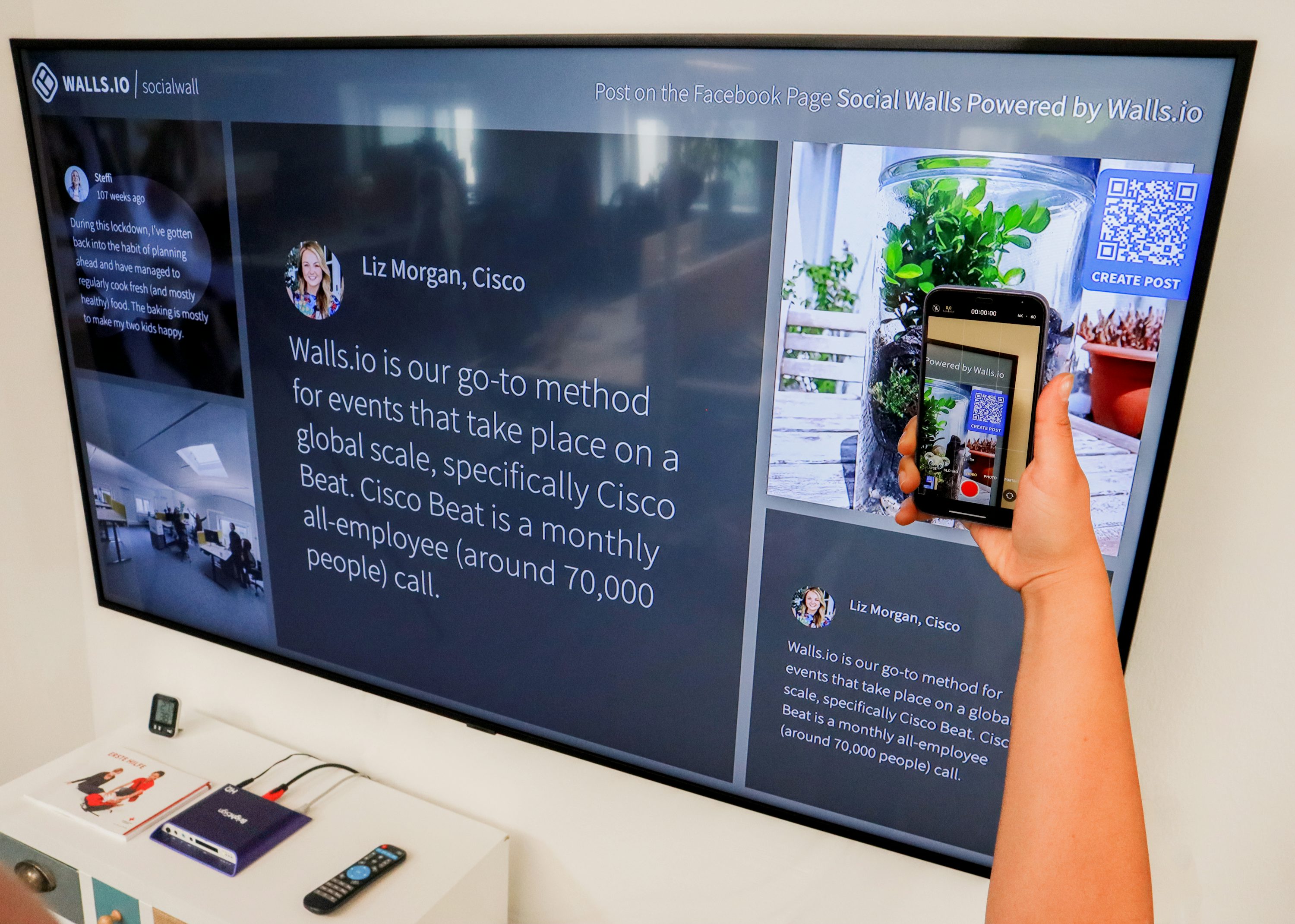 A person holds a smartphone up to scan a QR code displayed on a large screen; illustrative stock photography, not a UAE event or EquiSecure client.