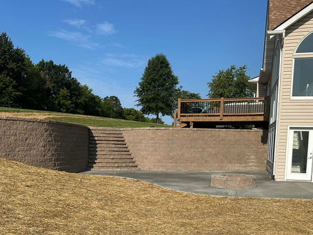 Retaining Wall with stairs and firepit with new concrete pad 