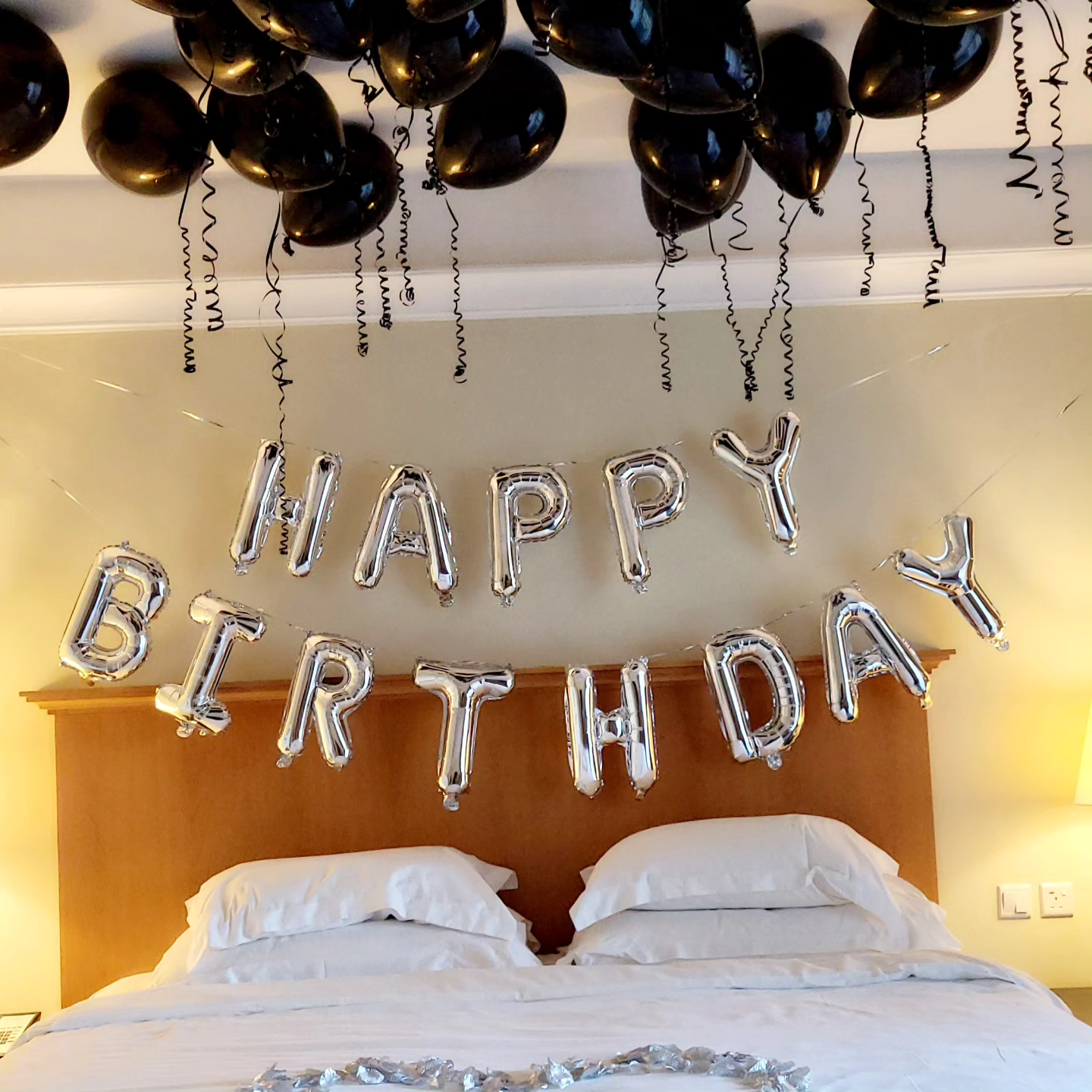 Hotel room balloon decorations set up on Black and silver