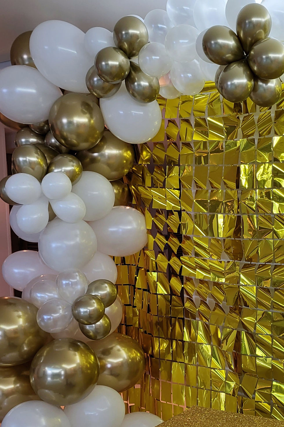 Thumbnail: Balloon garland set up, including gold backdrops