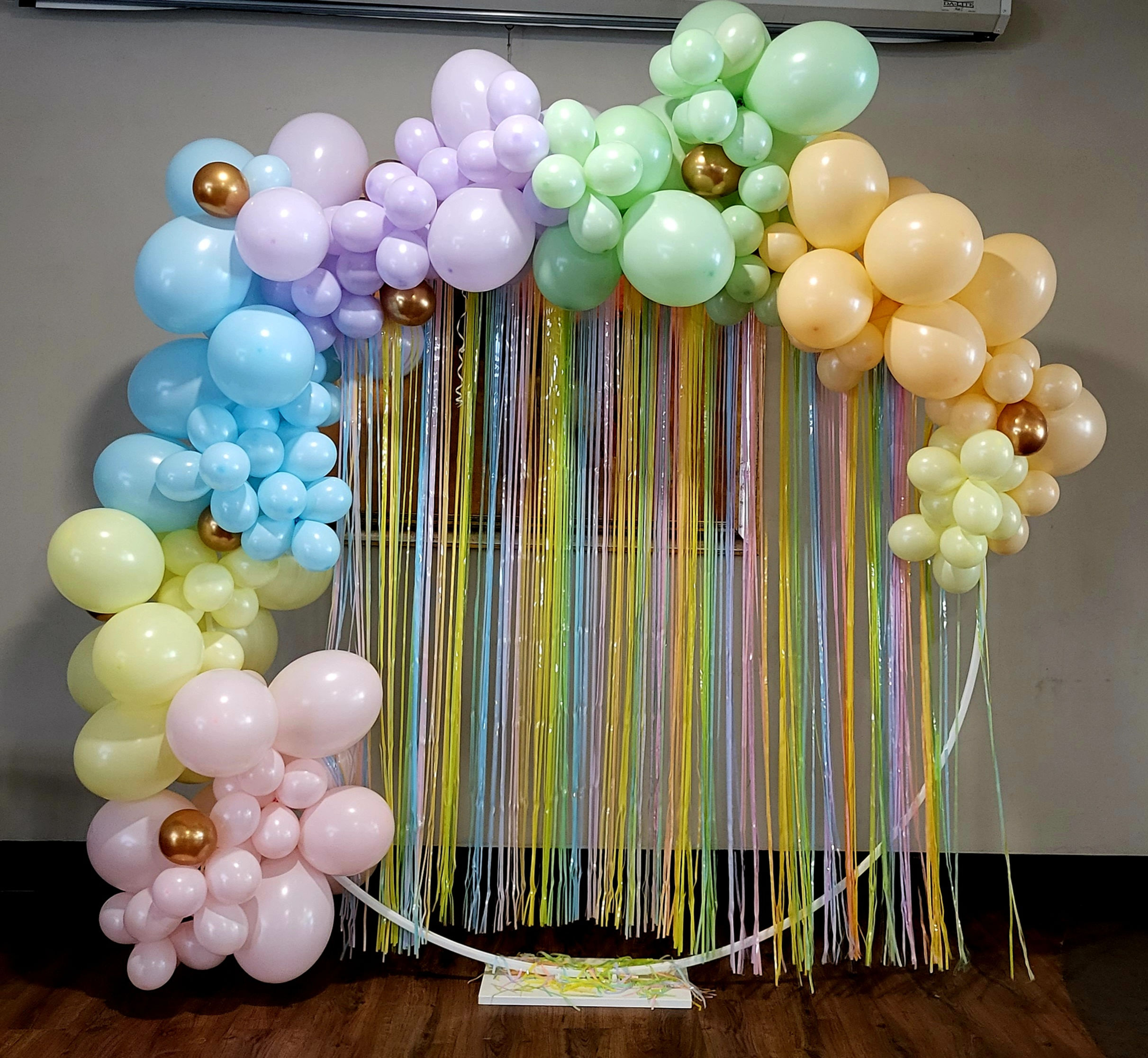 Pastel balloon arch garland on frame with 2 pastel curtains
