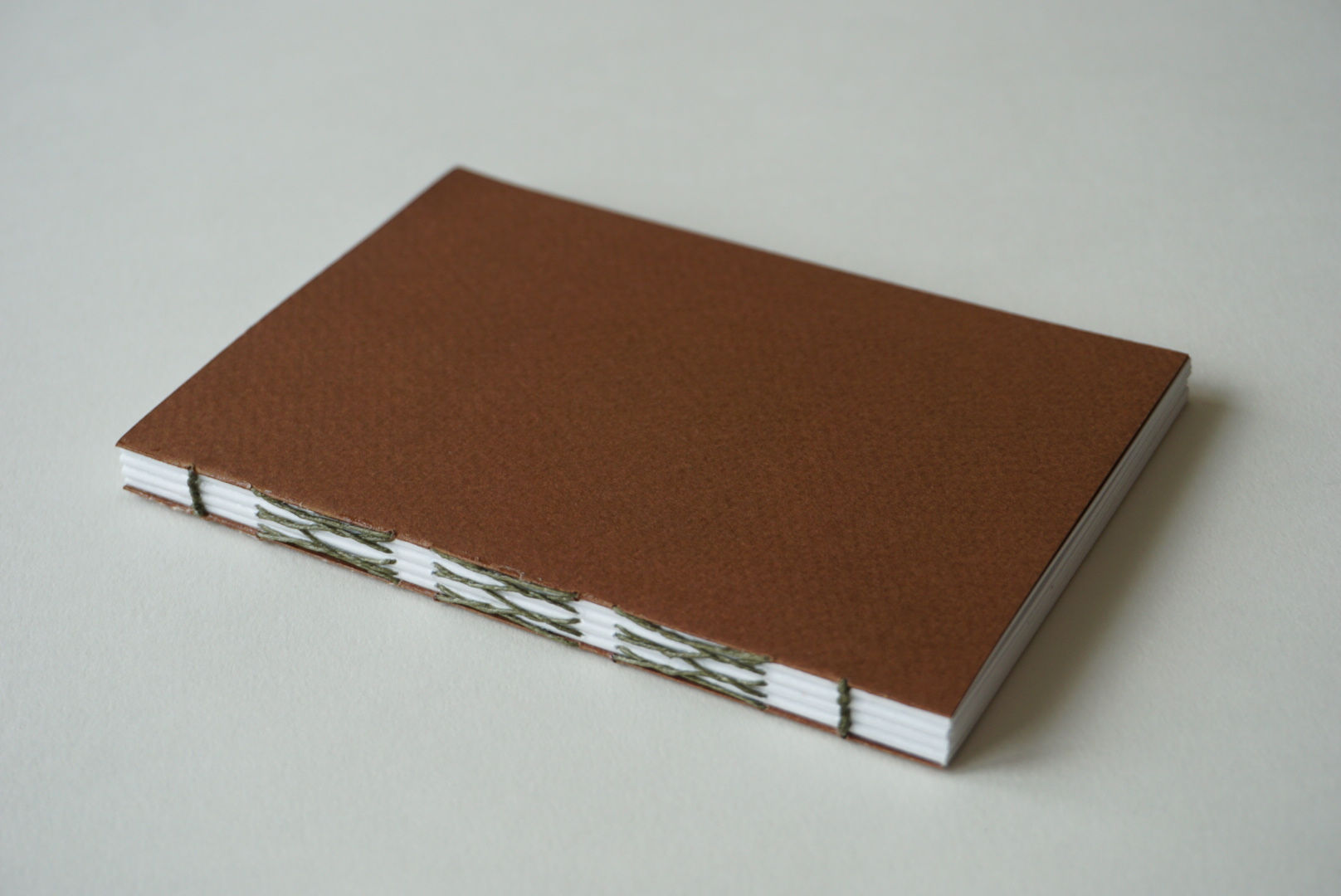 a6 french link stitch - brown with dark green thread