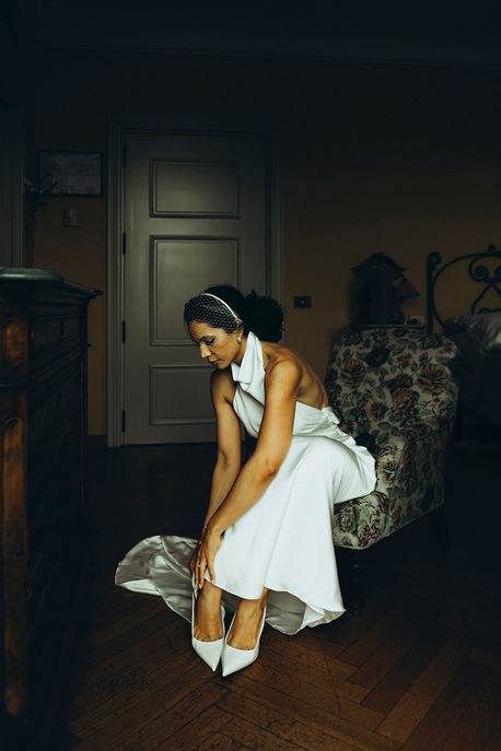 bride putting on wedding shoes