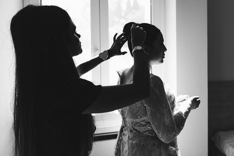 black and white portrait of woman adjusting bride's hair for wedding in Rome