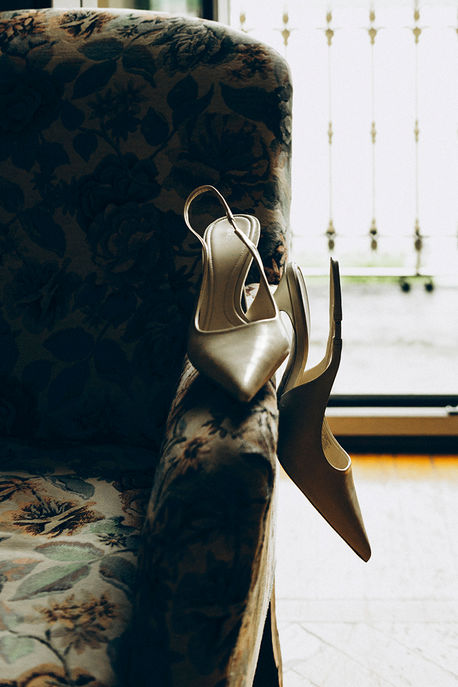 bride's shoes in detail in dramatic backlight