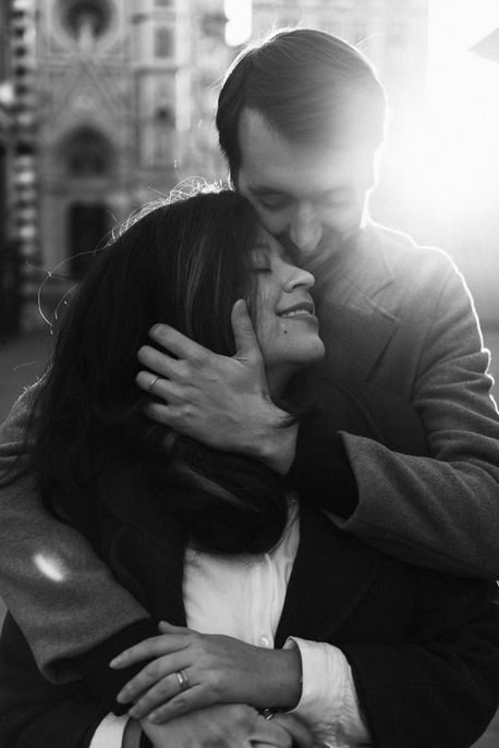 black and white close-up portrait of couple snuggling in a beautiful sunrise in Florence
