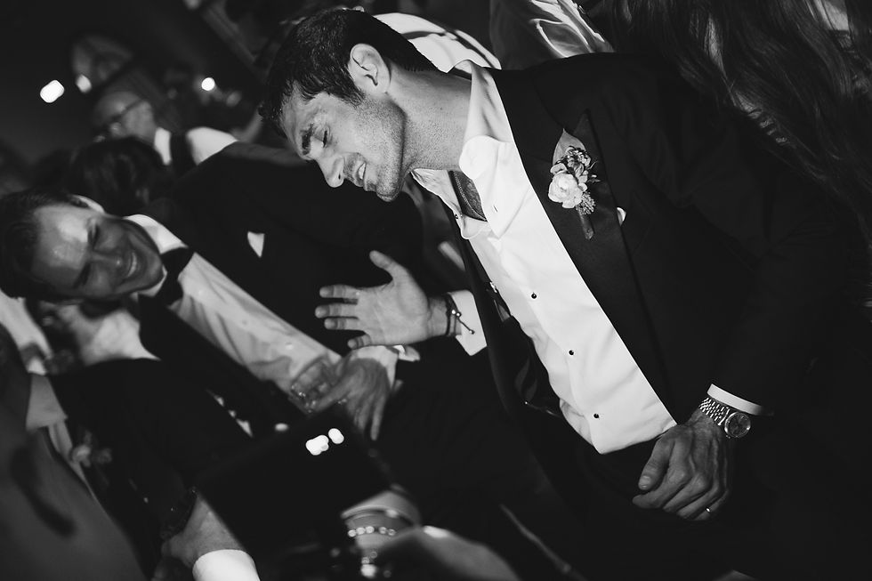 guests dance and smile during at a lively wedding party.
