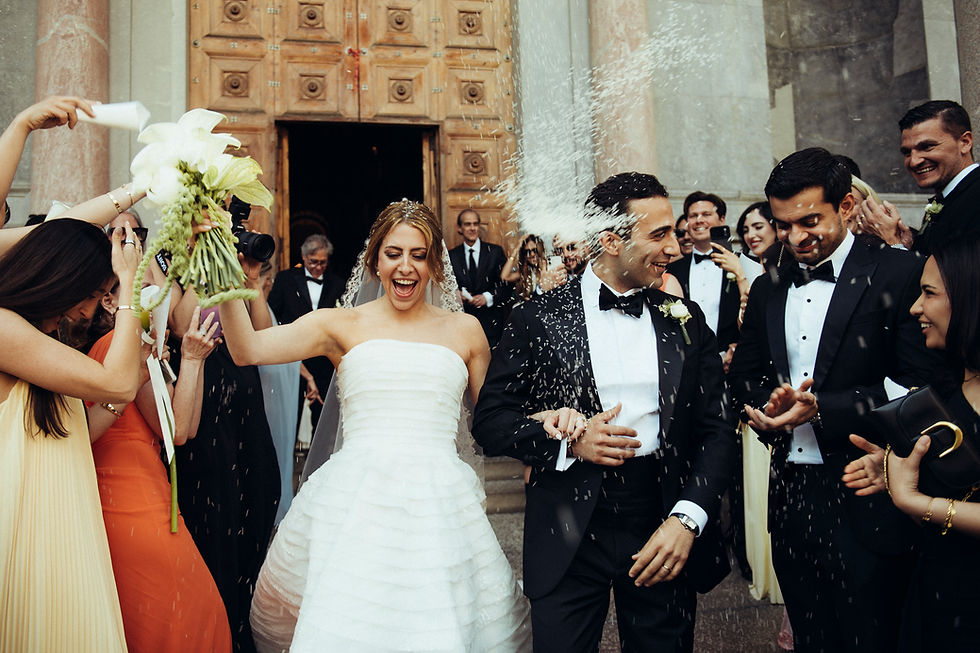 tossing rice as bride and groom exit church