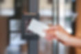 Door access control - young woman holding a key card to lock and unlock door..jpg