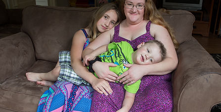 Diana and family sitting together on their couch