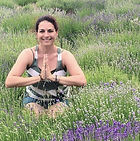 Woman in prayer position in a field of lavender