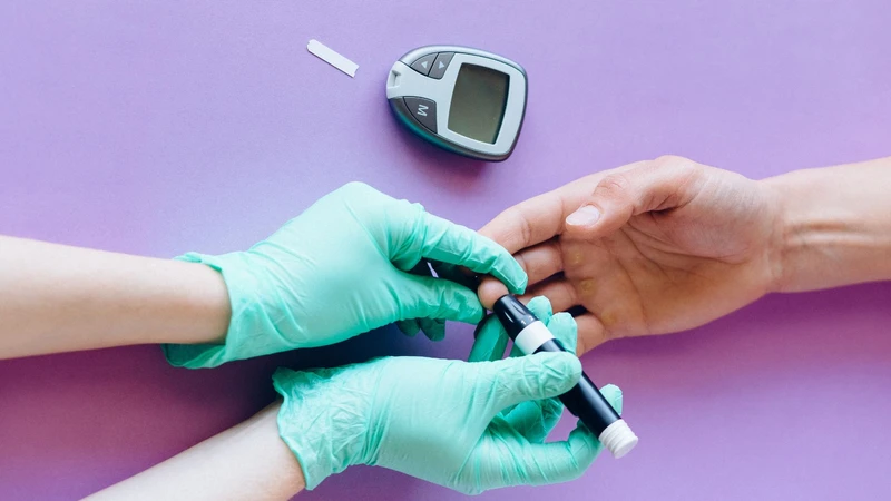 a healthcare professional taking a finger prick blood glucose reading