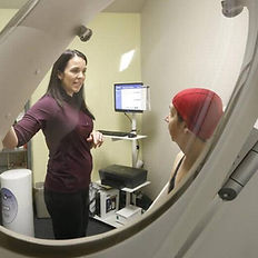 Kelly Sherman, MS, NC, CPT helps a client during their BodPod assessment.