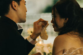 Groom gently wiping tears from bride's face at wedding – Thailand