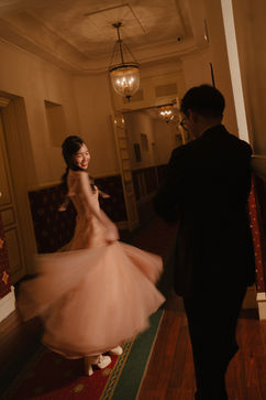 Thảo twirling in her prewedding dress with Hiệp in a hallway – Da Lat