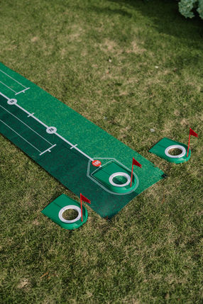 Outdoor putting green mat with red flags on grass – Binh An Village, Vung Tau
