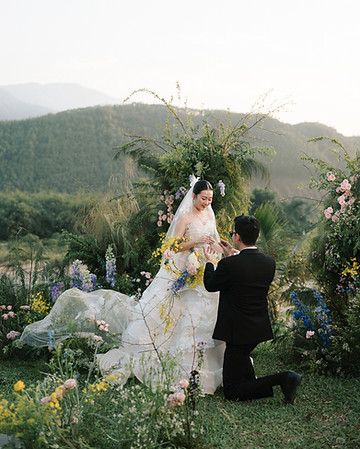 couple exchange ring in garden vows ceremony