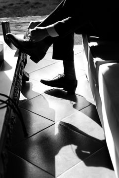Groom tying his wedding shoes during A&L wedding – Binh An Village, Vung Tau