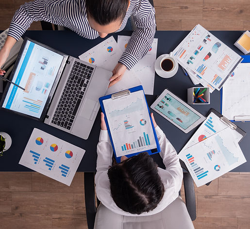 top-viewtop-view-manager-employee-doing-teamwork-business-office-looking-charts-laptop-dis
