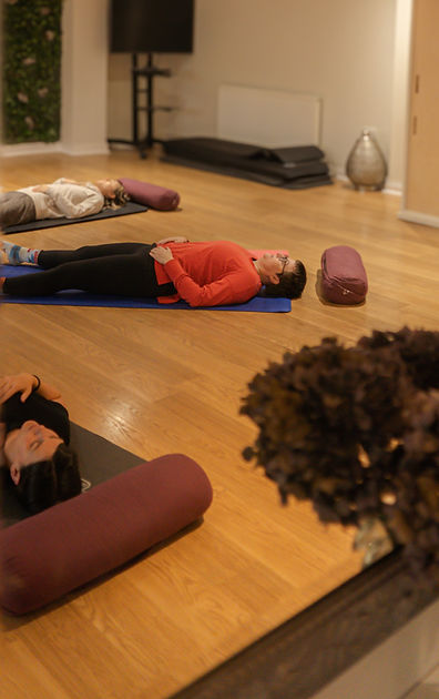Women resting in savasana during a gentle yoga class in Altrincham