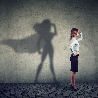 Side view of a business woman imagining to be a super hero looking aspired. .jpg