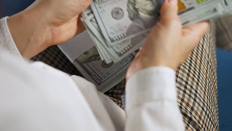 hands-counting-us-dollar-bills-or-paying-in-cash-concept-of-investment-success-financi-SBI