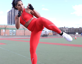 Jackie Arista outside in red workout set