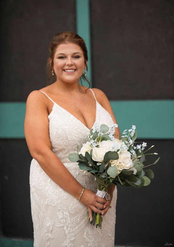 Bride with bouquet, white and blue flowers and greenery
