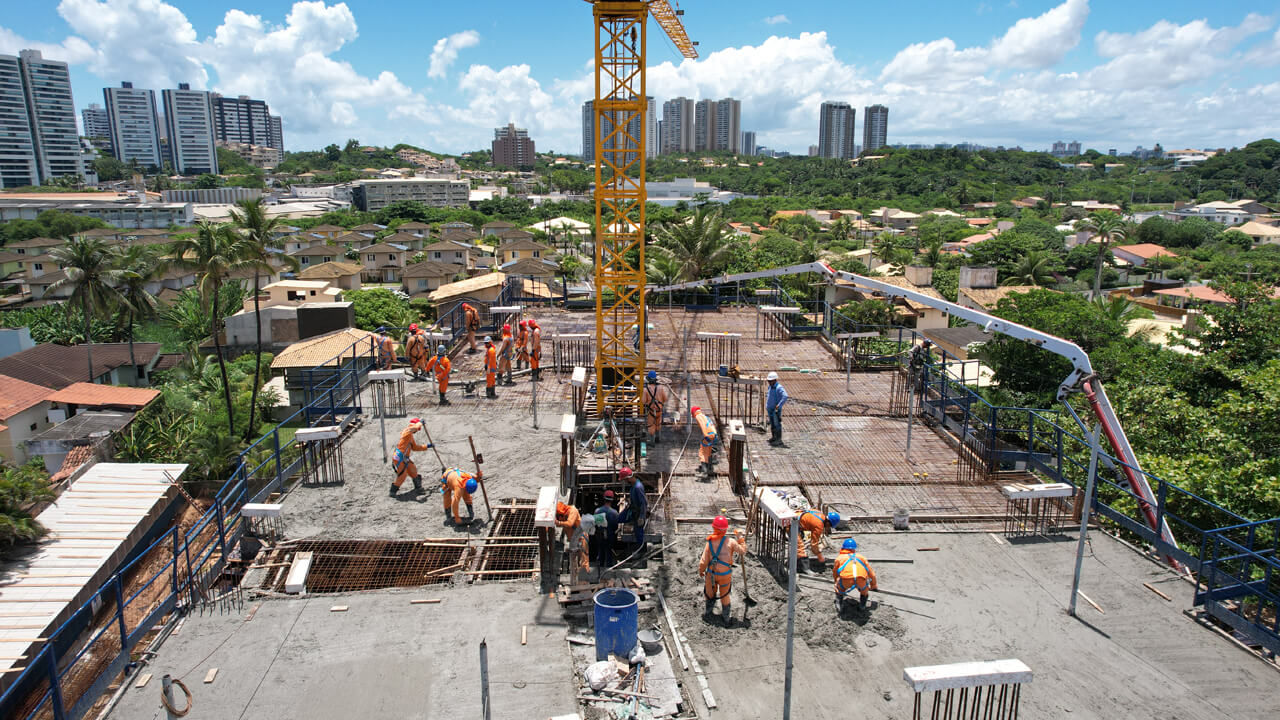 Vista aérea de obra com grua e concretagem em Salvador, BA.