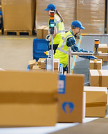 Cardboard warehouse boxes stacked on industrial shelving for storage and logistics