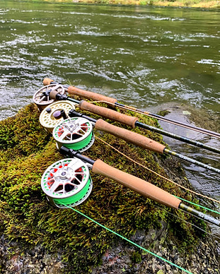 Fly Rods and Reels on mossy bolder near river