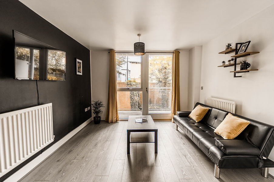 Modern living room with black wall, sofa, and coffee table HOME.