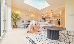 Modern open-plan living room with skylight and kitchen